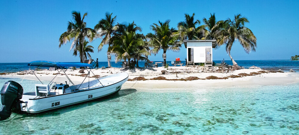 Boat mored on a small beach island in Belize