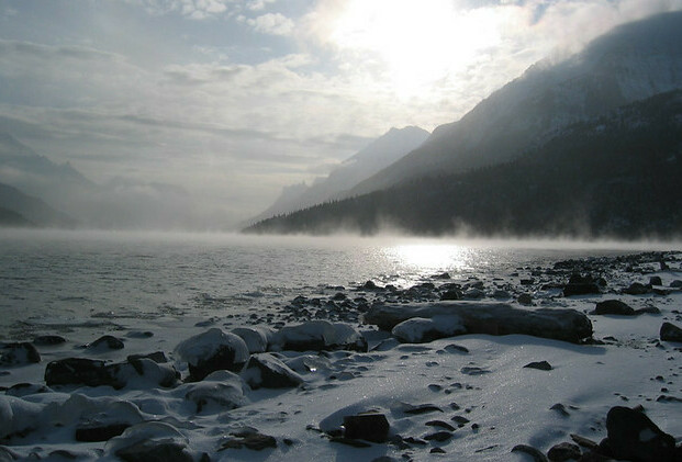 Waterton lake in the winter with snow and ice and fog